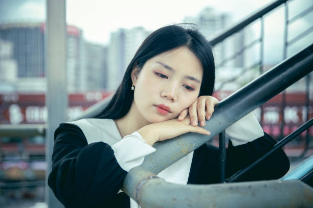 istock Sadness teenager sitting on steps lonely 1339811403