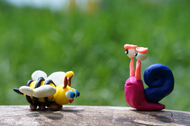 istock Figure of a snail and a bee close-up. 1339814444