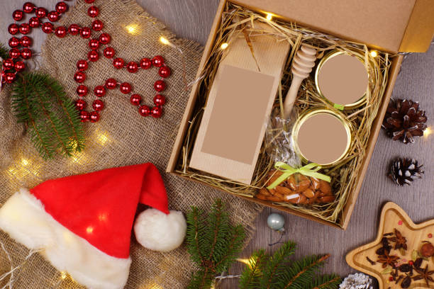 istock Christmas present surrounded by holiday attributes on gray background in layout 1339815760