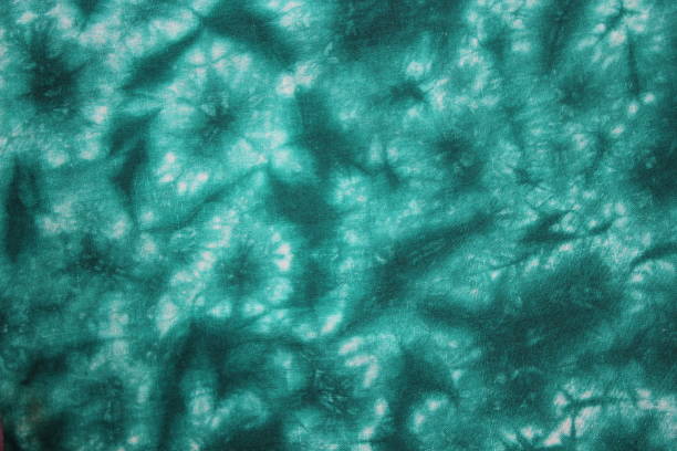 Tie dye green background with half circle layers of dye pattern stock photo
