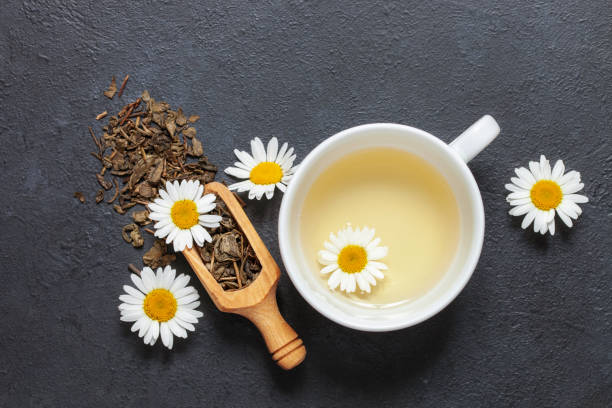 istock Chamomile herbal tea in a cup on a dark background. Top View 1339817704
