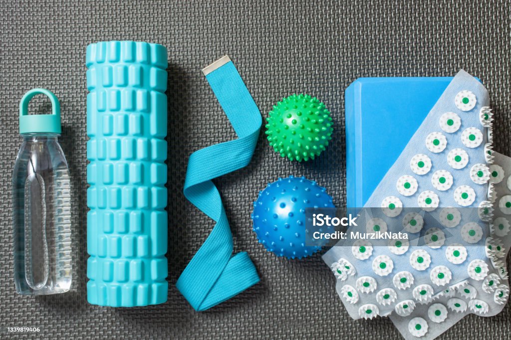 Fitness or yoga background. Equipment for  home training. Top view. Flat lay. Knolling Foam Roller Stock Photo