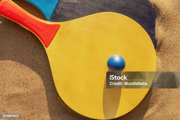 Beach Tennis Rackets And Ball In The Sand Summer Sport And Games Concept Top View Stock Photo - Download Image Now