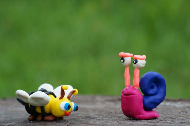 istock Figure of a snail and a bee close-up. 1339821106