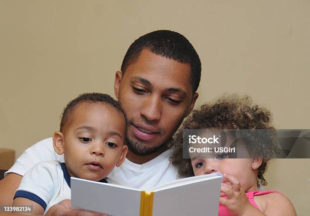 Two Generation Family Reading Father Son Niece Stock Photo - Download Image Now - Reading, Father, Child