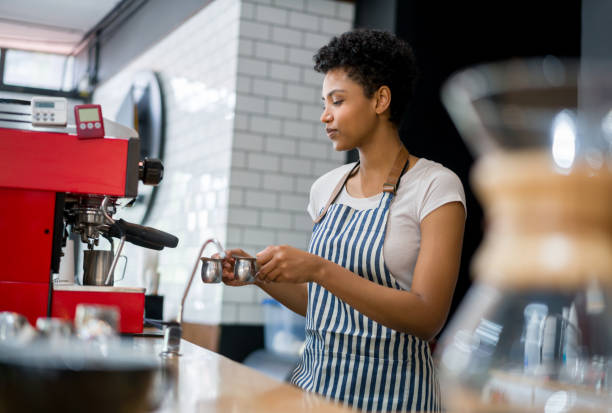 istock Happy barista making coffee at a cafe on a machine 1339827122