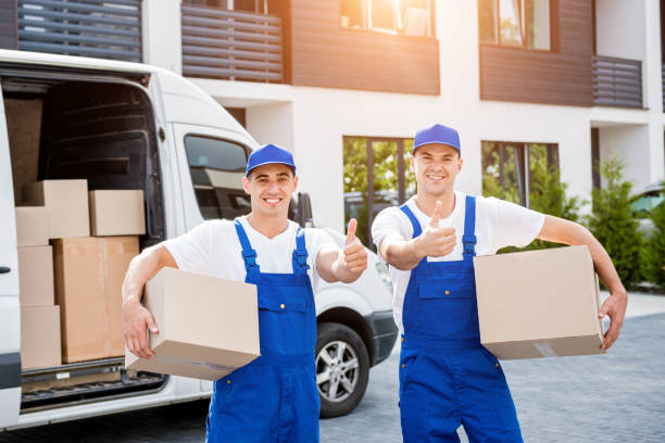 istock Two removal company workers unloading boxes from minibus into new home 1339831872