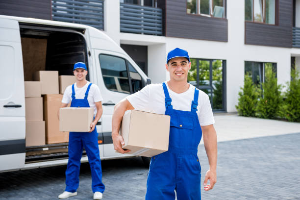 istock Two removal company workers unloading boxes from minibus into new home 1339831997