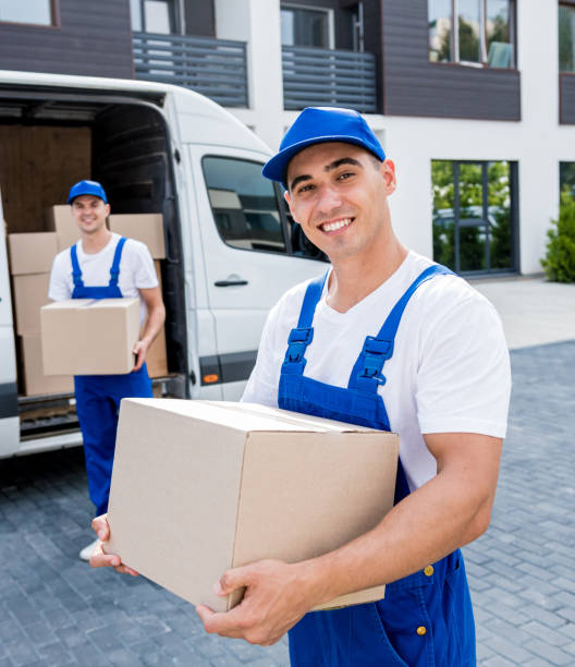 istock Two removal company workers unloading boxes from minibus into new home 1339832639