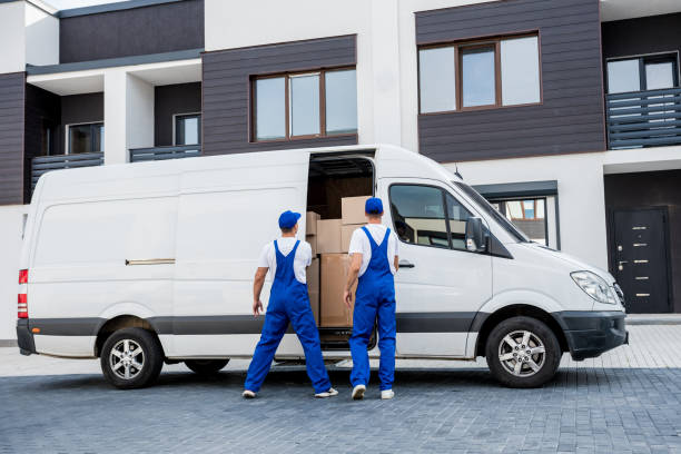 istock Two removal company workers unloading boxes from minibus into new home 1339832687
