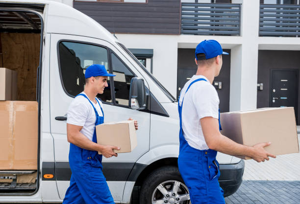 istock Two removal company workers unloading boxes from minibus into new home 1339832735