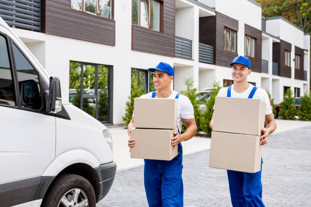 istock Two removal company workers unloading boxes from minibus into new home 1339832783