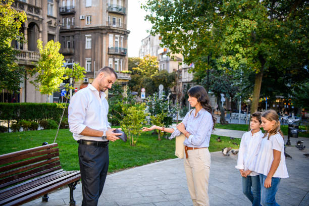 Divorce Maintenance Laws of India: What You Must Know ! Man and his Wife Have a Serious Discussion about Alimony in the City Park with Children. A Displeased Couple has a Harsh Debate in the Park. A Young Couple is Having an Unpleasant Talk Due to Financial Problems, while Kids are Listening. alimony divorce stock pictures, royalty-free photos & images