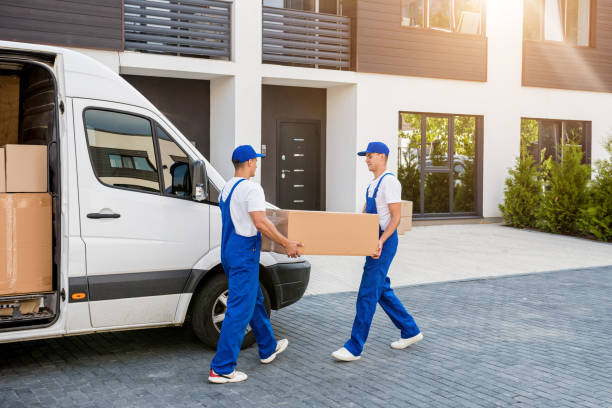 istock Two removal company workers unloading boxes from minibus into new home 1339833188