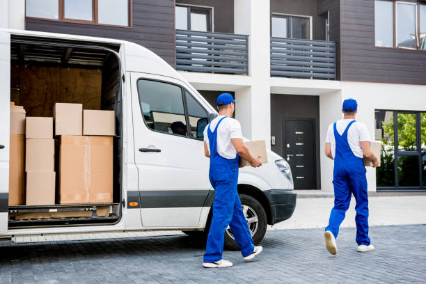 istock Two removal company workers unloading boxes from minibus into new home 1339833243