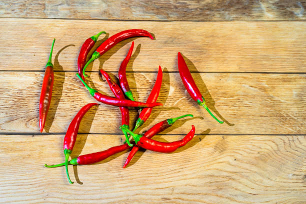istock Red hot peppers on wooden table 1339834047