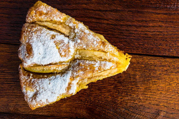 istock Sliced apple pie with cinnamon on rustic wooden table 1339835437