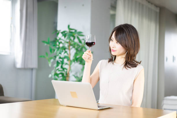 istock A young woman participating in an online drinking party 1339835528