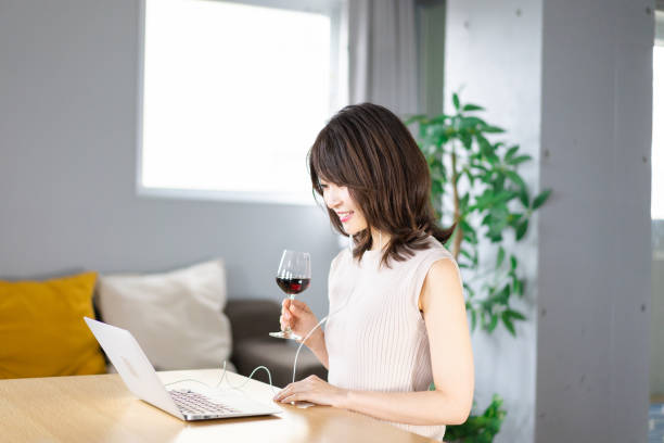 istock A young woman participating in an online drinking party 1339835529