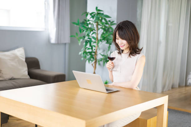 istock A young woman participating in an online drinking party 1339835556