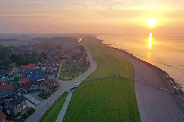 Photo of Aerial from the village Wierum at the Wadden Sea in the Netherlands at sunset