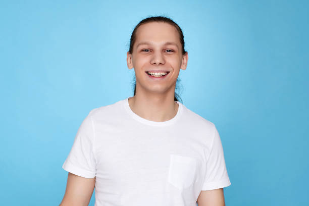 istock young handsome guy in white shirt smiling 1339838754