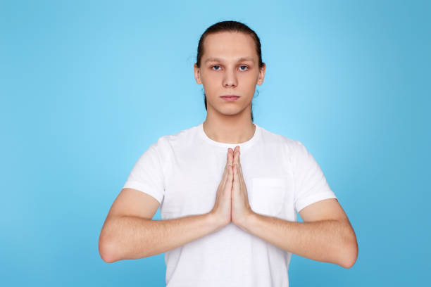 istock calm man holding hands in yoga gesture 1339839454