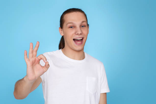 istock young handsome man in t-tshirt showing Ok gesture 1339839951