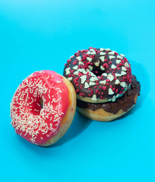 istock Colorful round donuts with filling on a blue background. Sweets. 1339840243