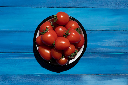 Fresh ripe tomatoes on wood