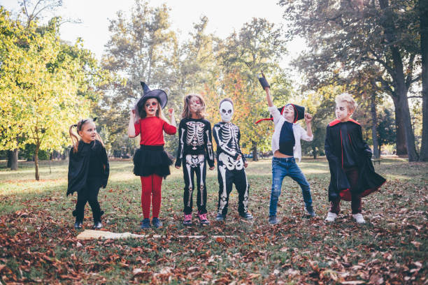 istock Halloween Masked Kids In The Park 1339844389