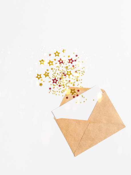 istock Open brown envelope with blank white card and various stars with imitation of explosion 1339844859