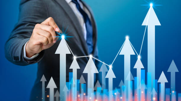 istock Businessman draws arrow graph corporate future growth. Businessman pointing arrow graph corporate future growth plan. Business development to success and growing growth year concept. 1339846128