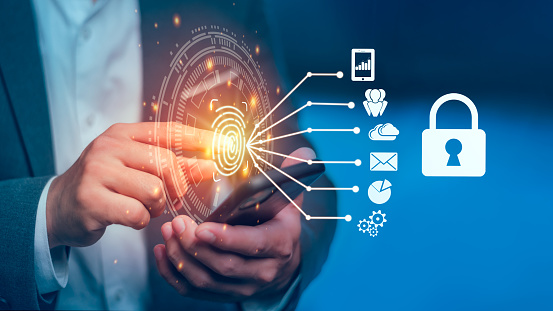Fingerprint scan provides security access with biometric identification. Businessman using fingerprint indentification to access personal financial data. Technology Safety and biometric security.