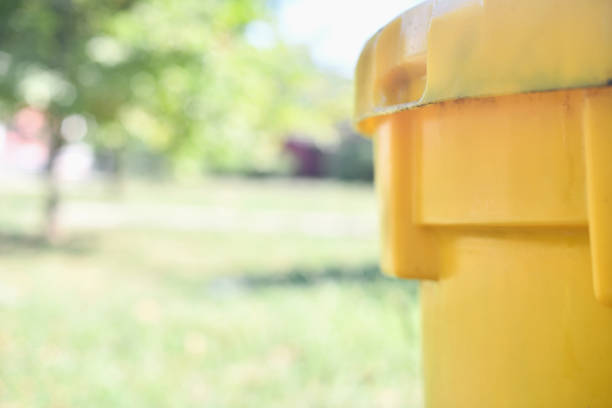Yellow dumpster for collection of used oil, Europe.