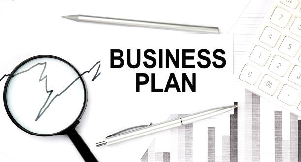 istock Business plan document with pen,graph and magnifier,calculator 1339849187