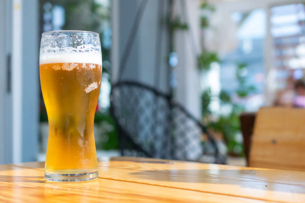 istock beer in a glass on a brown table with a blurry background 1339851003