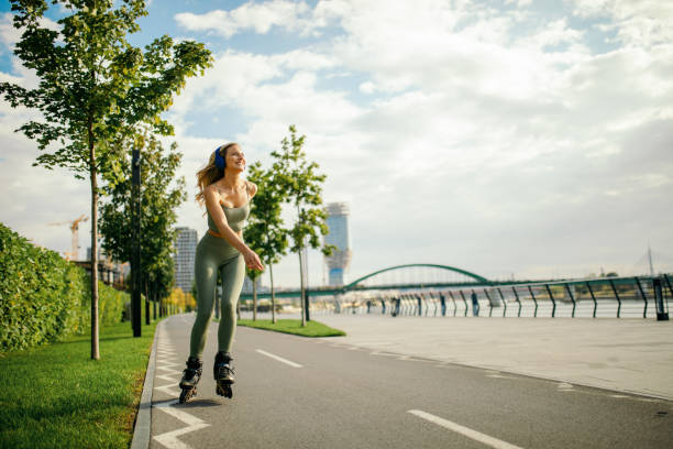 Beautiful young woman enjoying roller skating in urban area. She is beautiful and very happy