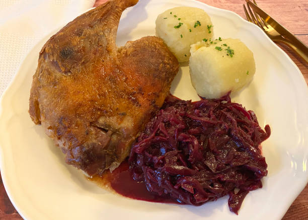 istock Roasted goose with red cabbage and potato dumplings. 1339854644