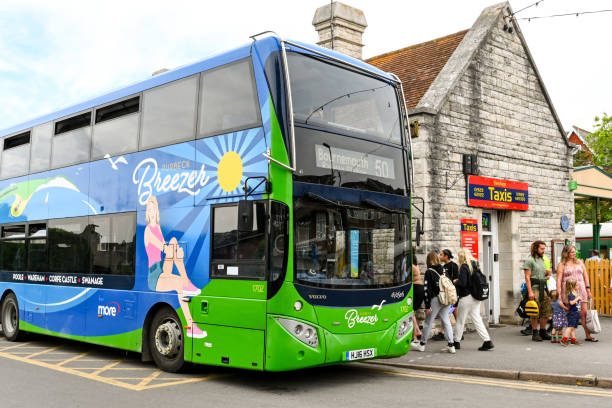 Swanage, Dorset, England - June 2021: Public service bus picking up passengers from the bus stop outside Swanage railway station