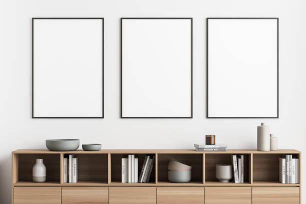 istock Three framed posters on a light beige wall of a living room 1339858341