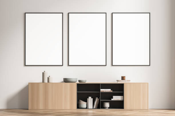 istock Three framed posters in the light beige waiting room with sideboard 1339861306