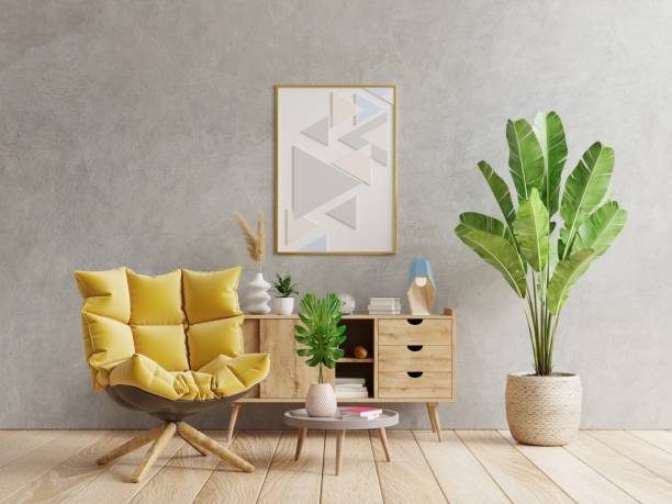 istock Poster mockup with vertical frame on empty dark concrete wall in living room interior with yellow armchair. 1339863084
