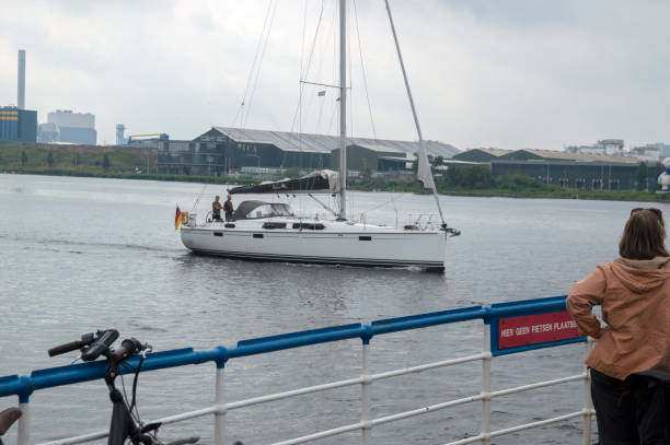 Sailboat Passing By A Ferry At Amsterdam The Netherlands 27-6-2020