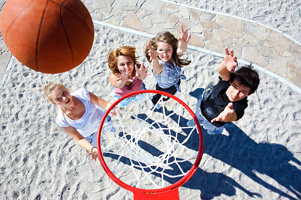 istock Three young women and a young man playing basketball 133986642