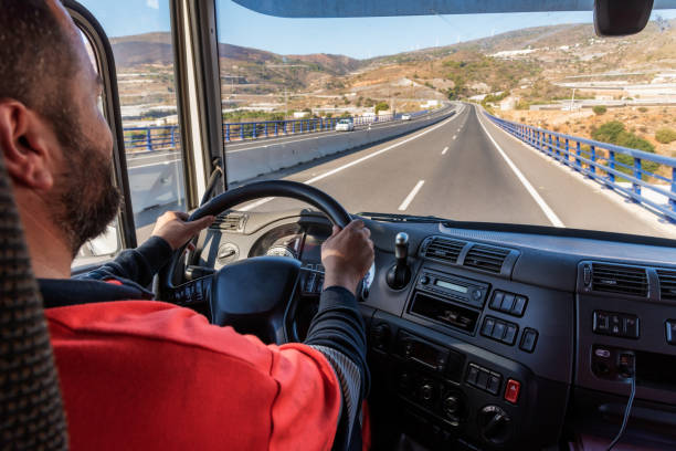 istock Truck driver driving on the highway, seen from inside the cab. 1339870218