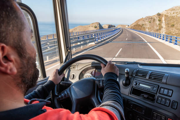istock Truck driver driving on the highway, seen from inside the cab. 1339870223