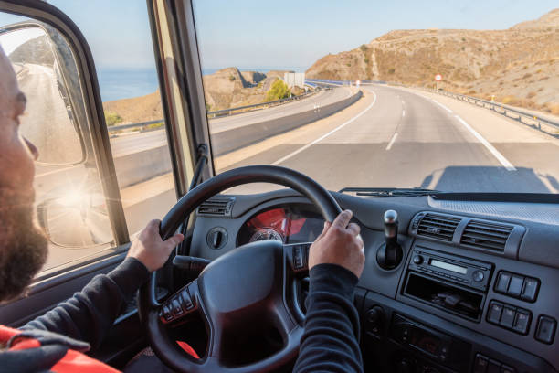 conductor de camión que conduce en la carretera, visto desde el interior de la cabina. - teamsters fotografías e imágenes de stock