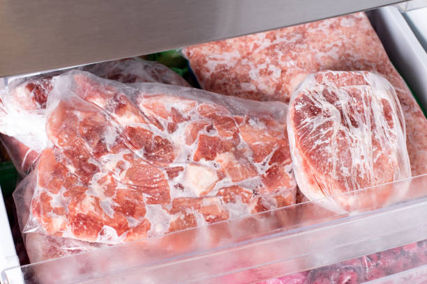 istock Frozen pork meat which has been vacuum sealed inside a fridge freezer. 1339872528