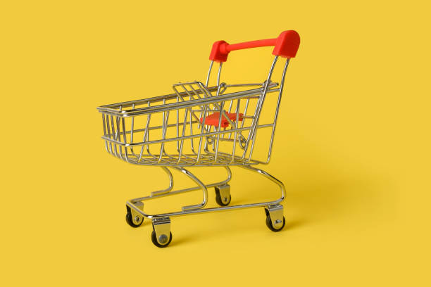istock Empty mini shopping basket isolated on yellow background. Retail. 1339875549